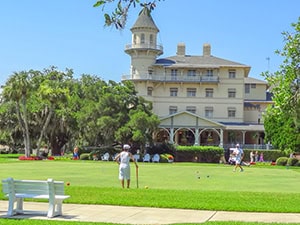 people playing croquet at a resort