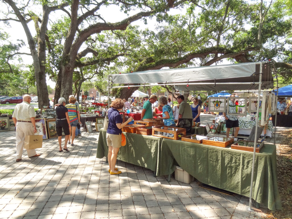 people at an antique market in a park