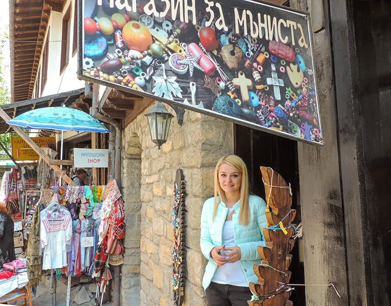 a shop keeper standing outside her shop