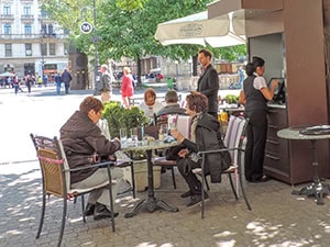 people at a cafe seen on a Eastern Europe river cruise