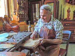 a craftman building a violin seen on a Eastern Europe river cruise