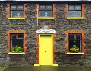 a yellow door on a house in Dingle, Ireland - Dingle Peninsula