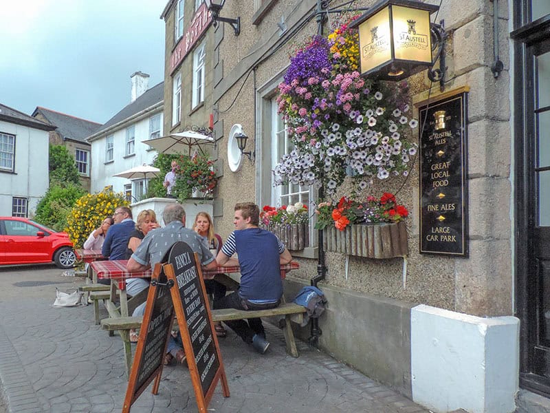 people having drinks outside a cafein St Agnes - one of the places to visit in Cornwall