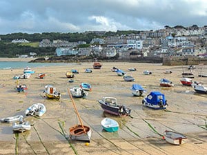 boats in a harbor at low tide