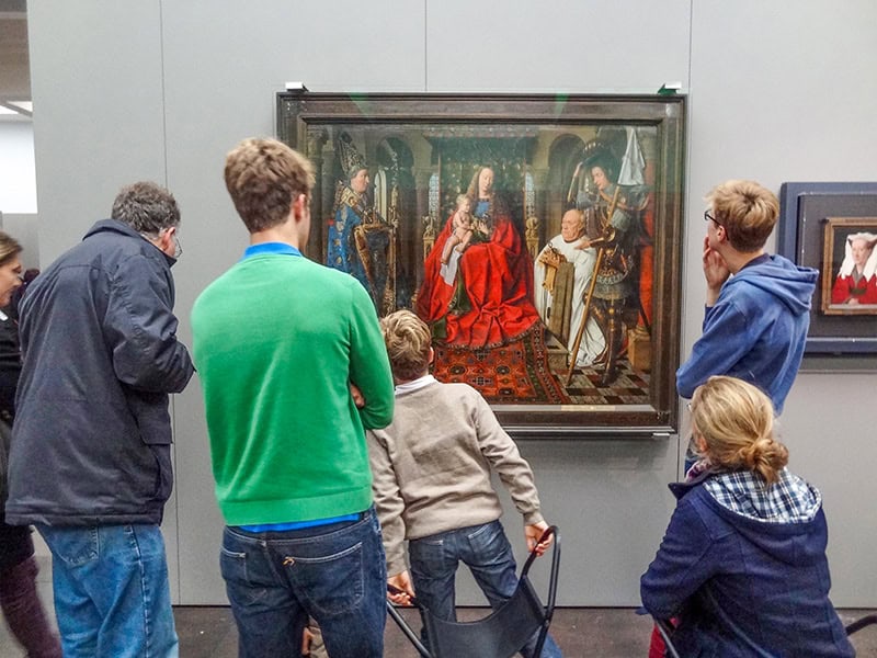 People looking at a paining in a museum