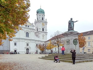 a man taking a photo of a child in front of a cathedral seen on a day trip from Munich