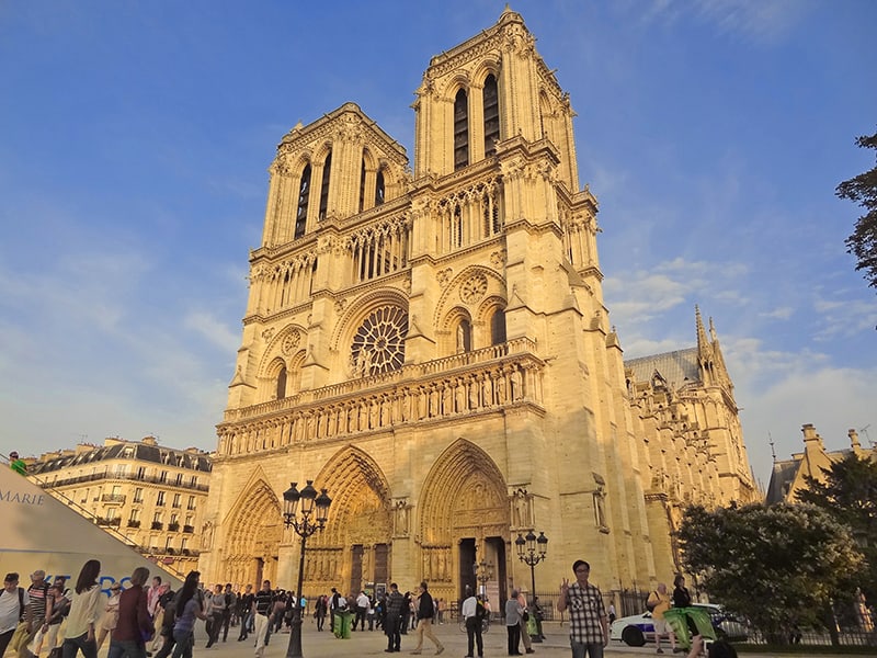 people by a cathedral - walking tour of Paris