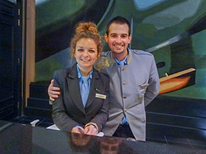a young man and woman at the front desk in a hotel lobby - seen on a black taxi tour of Belfast