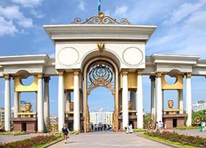people walking under an ornate arch, seen on a visit to almaty kazakhstan