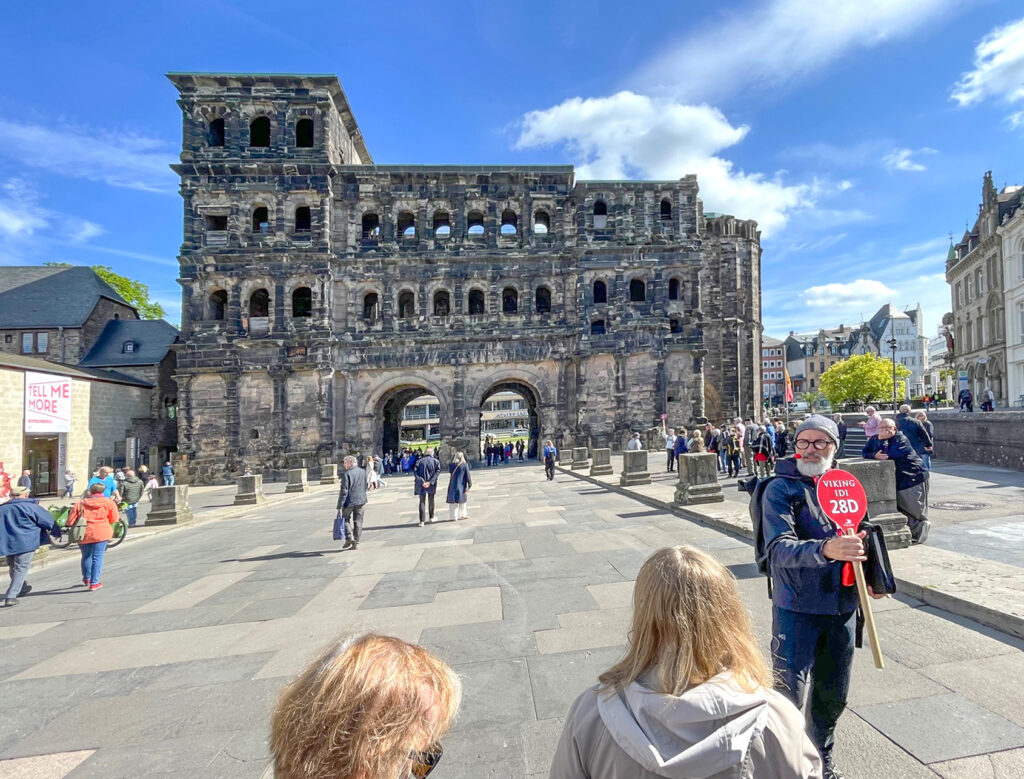 a tour guide by an ancient Roman gate seen on a Viking river cruise Paris to Prague