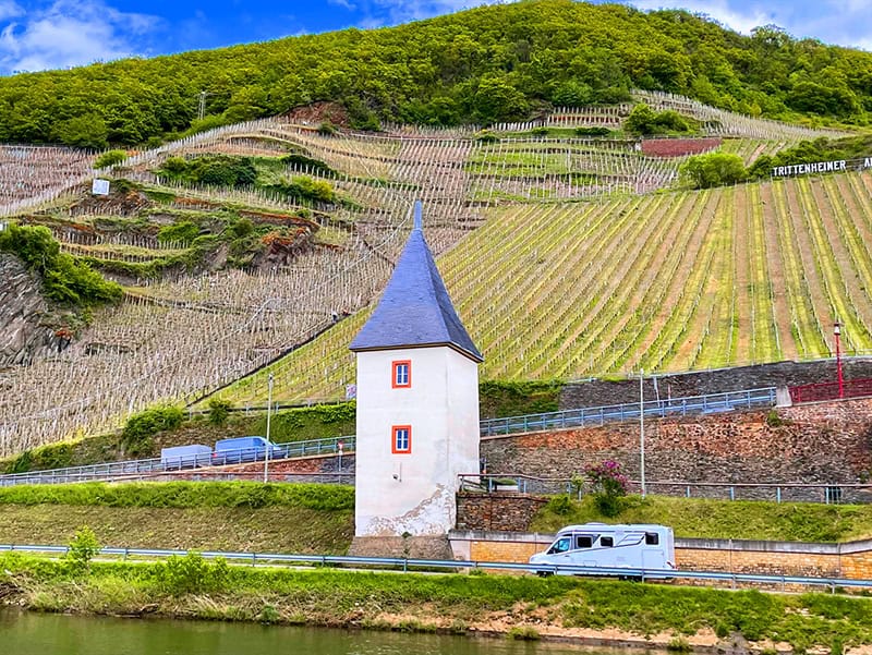a truck passing vineyards on a hillside see on a Viking river cruise Paris to Prague