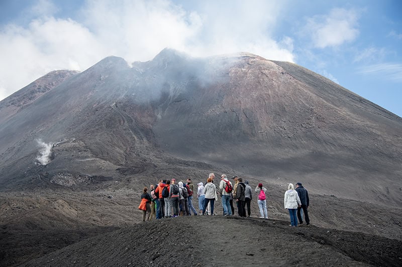 people looking at a volcano