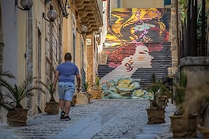 a staircase painted wwith a woman's face seen while seeing Sicily by car