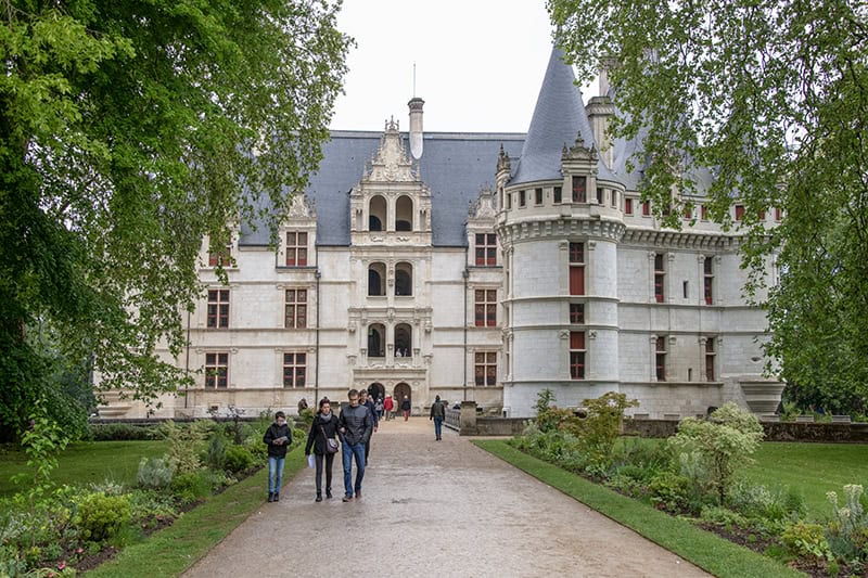 people walking in front of a castle