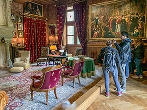 a couple looking at an exhibit in a chateau