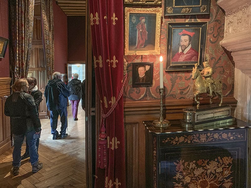 people walking past colorful exhibits in a mseum