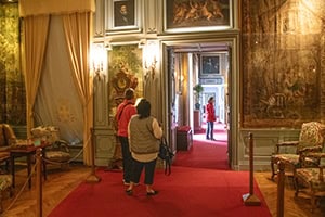 people in rooms in a chateau