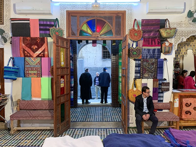 men standing in a shop doorway in Fez Morocco