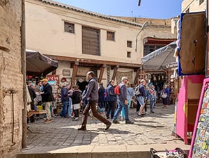 people walking along in a street market