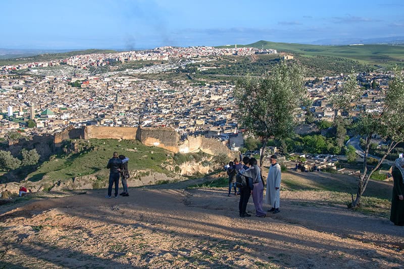 People looking at Fez Morocco from a hill outside the city