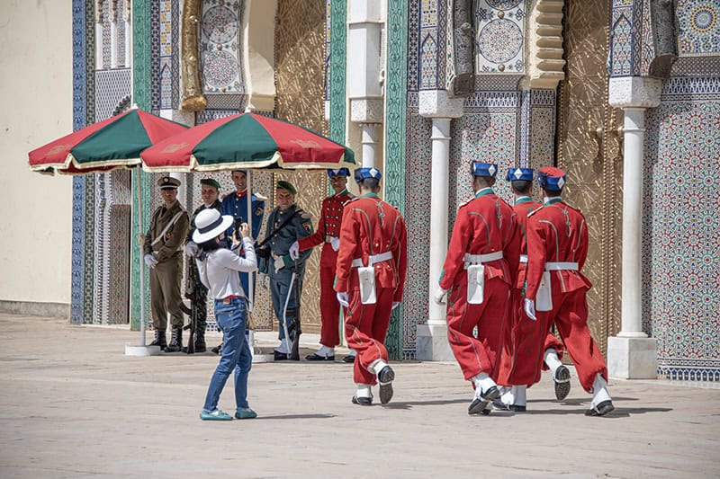 soldiers in bright red uniforms walking towards another group of soldiers