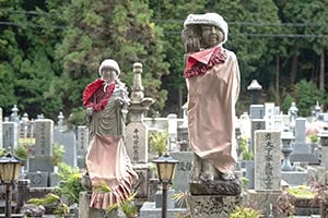 small statues on tombstones