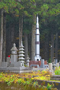 a large rockt placed on a tombstone in koyasan japan