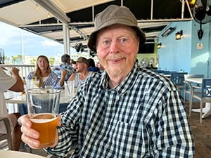 Bill Warelis holding a glass of beer