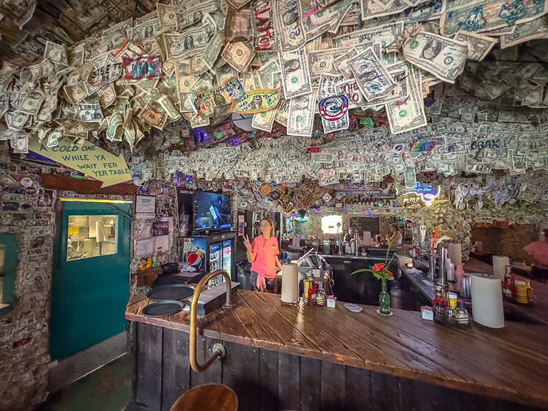 a bar with thousands of dollar bills hanging from the ceiling