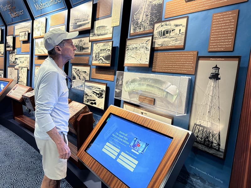 a man looking at a museum exhibit while on a road trip in the Florida Keys