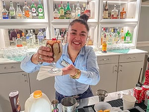 a female bartender holding a drink