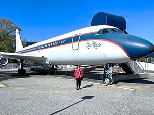 a woman standing in front of an airplane