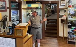 a man standing by a collection in a railroad museum