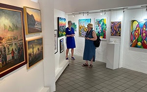 two women viewing an art exhibit seen on a trip from Orlando to Amelia Island