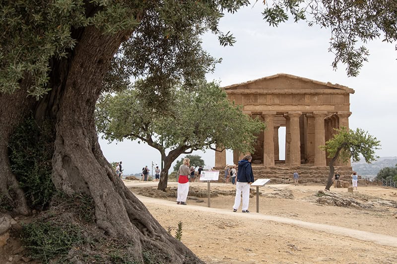 two women standing in front of a temple in Agrigento Sicily