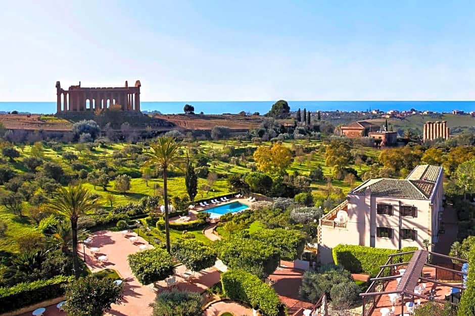 a hotels with a view of a temple and the sea